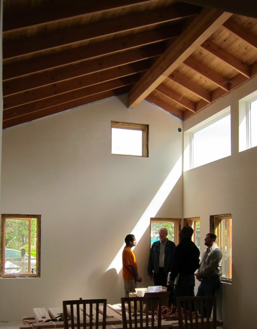 Beam of light shines on the eager learner as he speaks to the architect