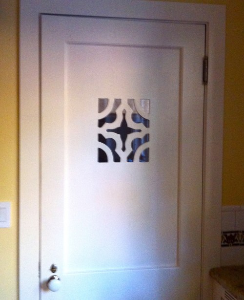 decorative cutout in a wood door panel