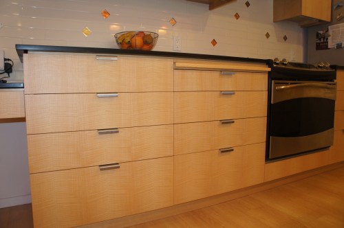 Figured Ash with mortised pulls and Richlite counters