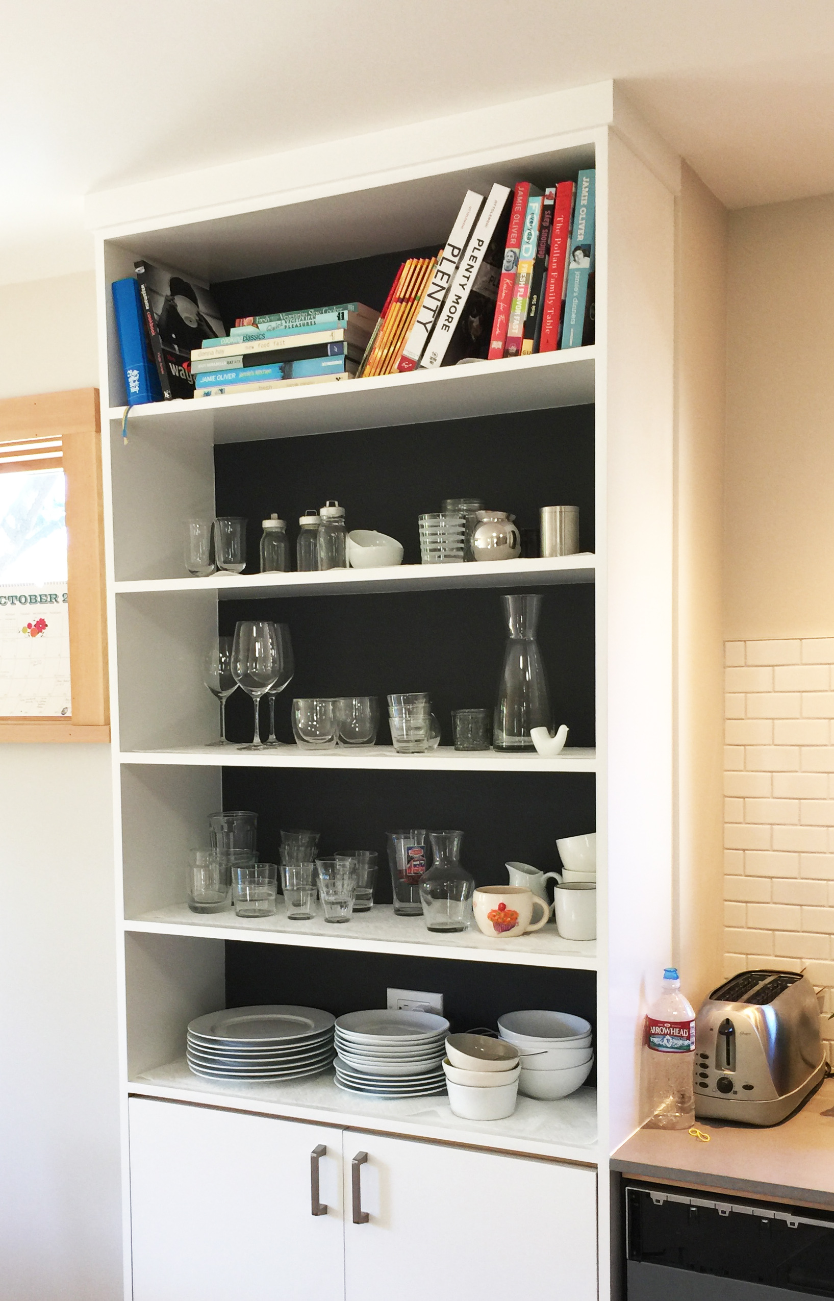 Tall Shelving Between Kitchen and Dining Area for All the Dishes